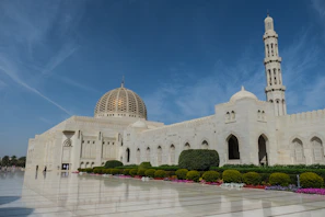 a large white building with a clock tower in the background