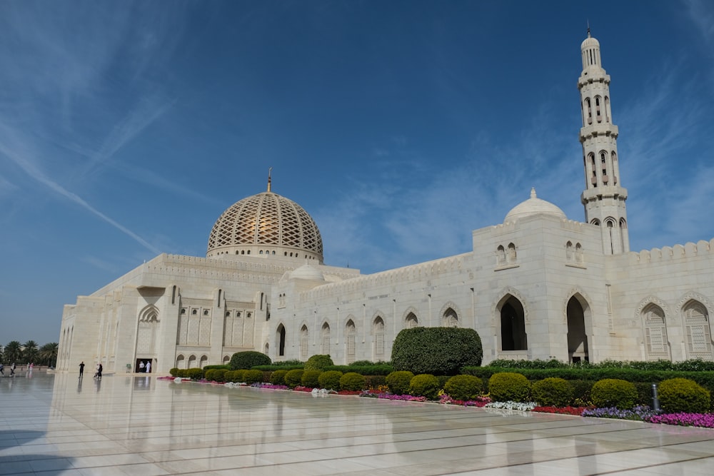 a large white building with a clock tower in the background