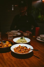 a wooden table topped with plates of food