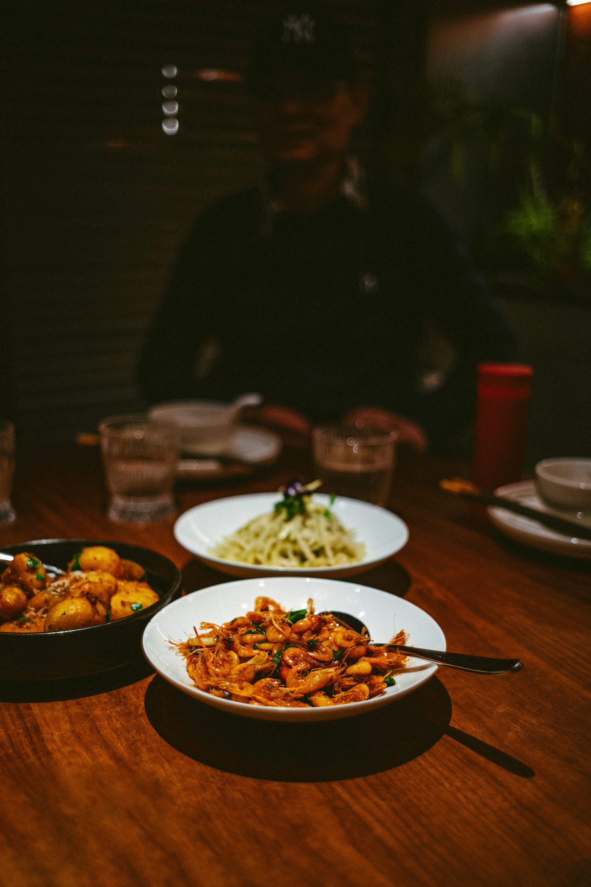 a wooden table topped with plates of food
