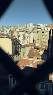 Invisible grill installed on a high-rise apartment window with city lights in the background