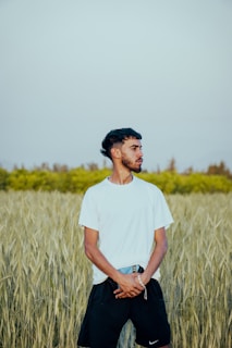 a man standing in a field of tall grass