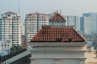 Close-up of a freshly installed shingle roof with vibrant Miami skyline in the background.