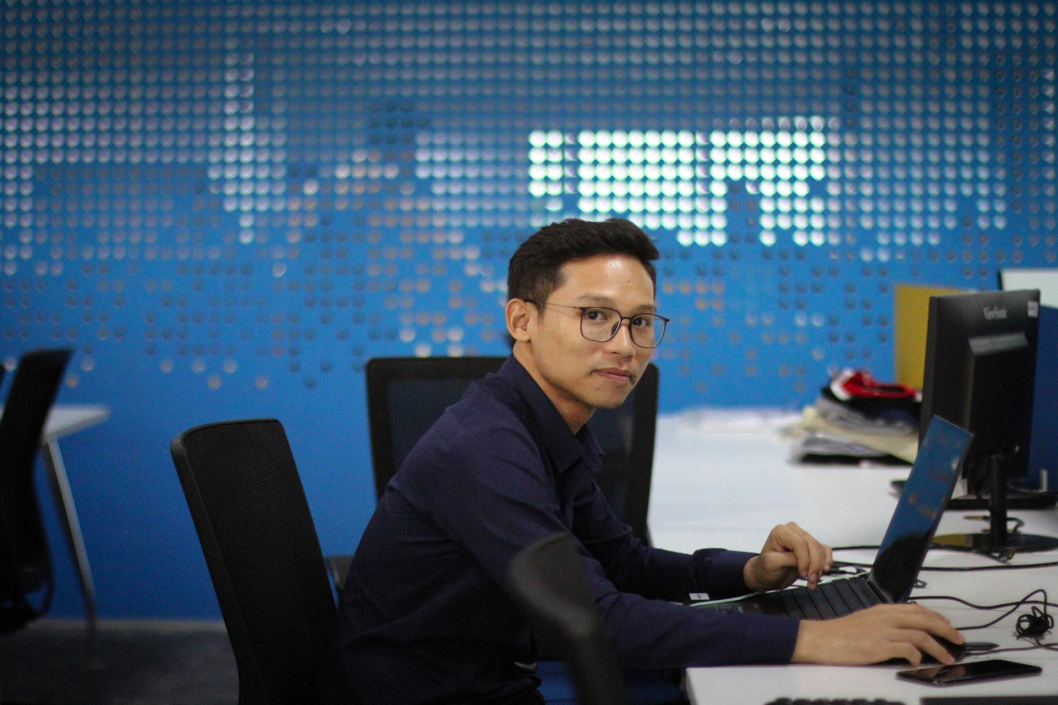 a man sitting at a desk with a computer