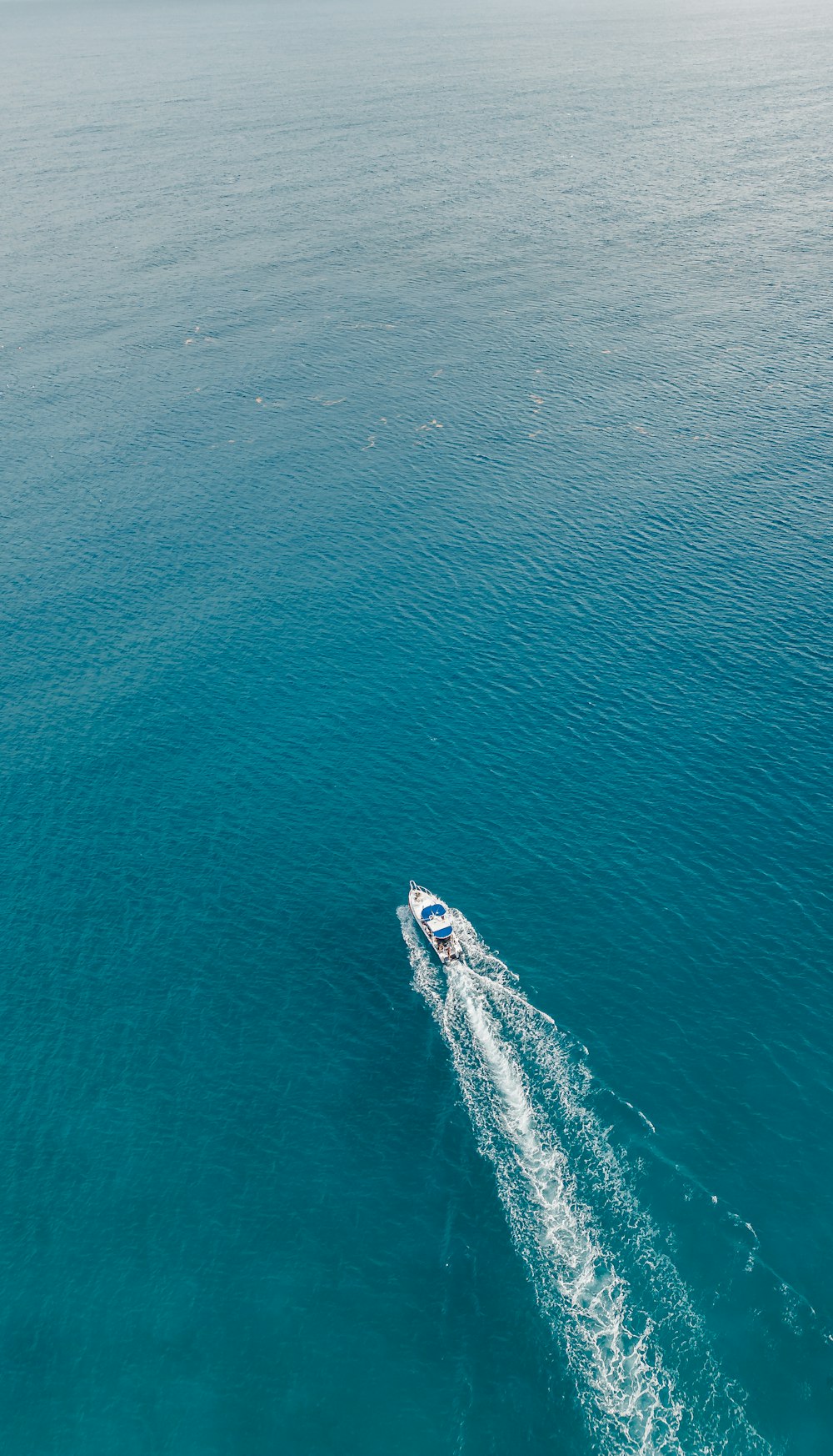 a small boat in the middle of the ocean