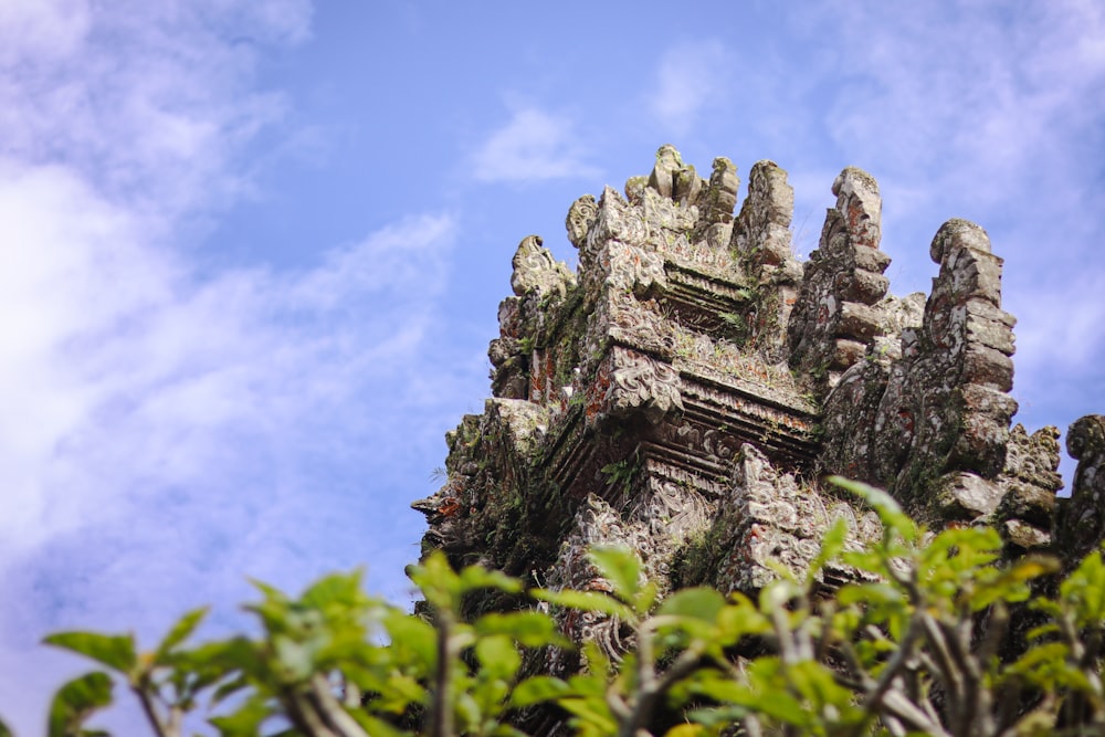 a very tall tower with a bunch of trees in front of it