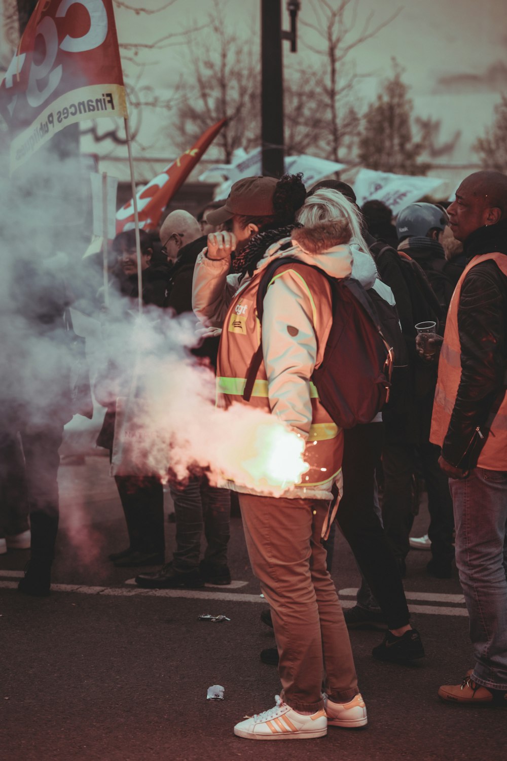 a man standing in front of a crowd holding a fire extinguisher