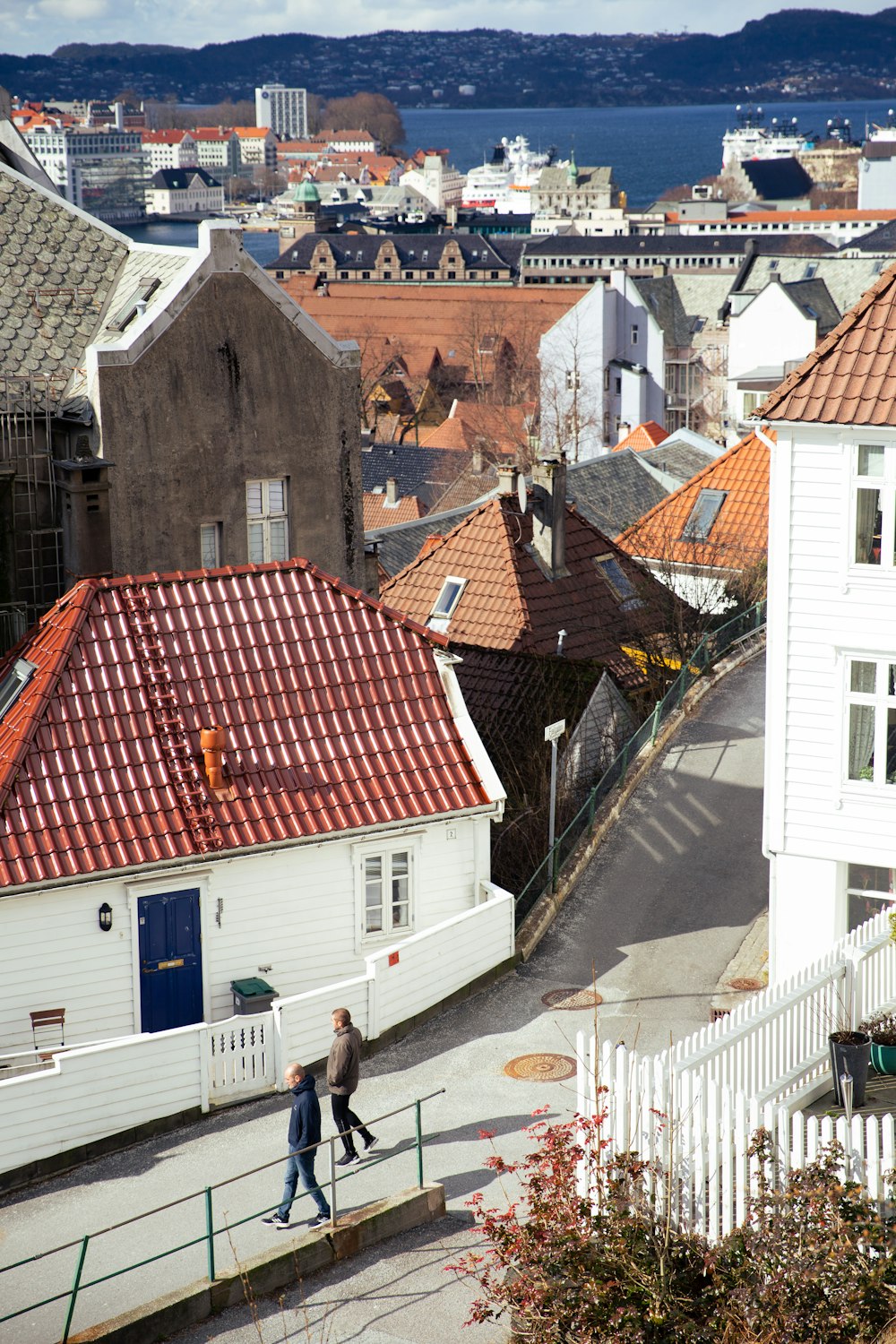 a couple of people that are walking down a street