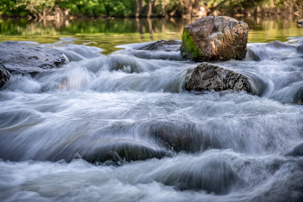 a stream of water with rocks in the middle of it