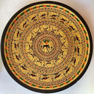 Close-up of a rare triangular collectible plate with intricate detailing.