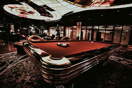 Interior view showcasing top-quality snooker tables neatly arranged under warm lighting.
