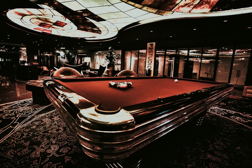 A cozy interior of a club with chess and poker tables.