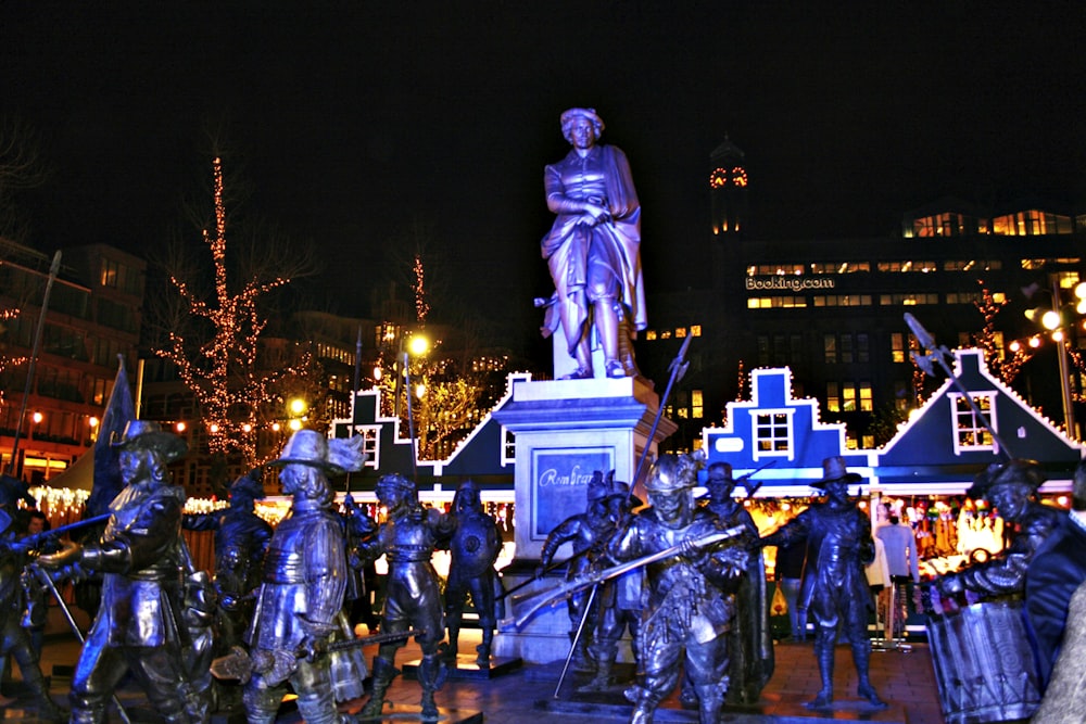 a group of people standing around a statue