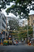A vibrant street scene in India with vehicles featuring toss star horns.