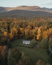 an aerial view of a house surrounded by trees