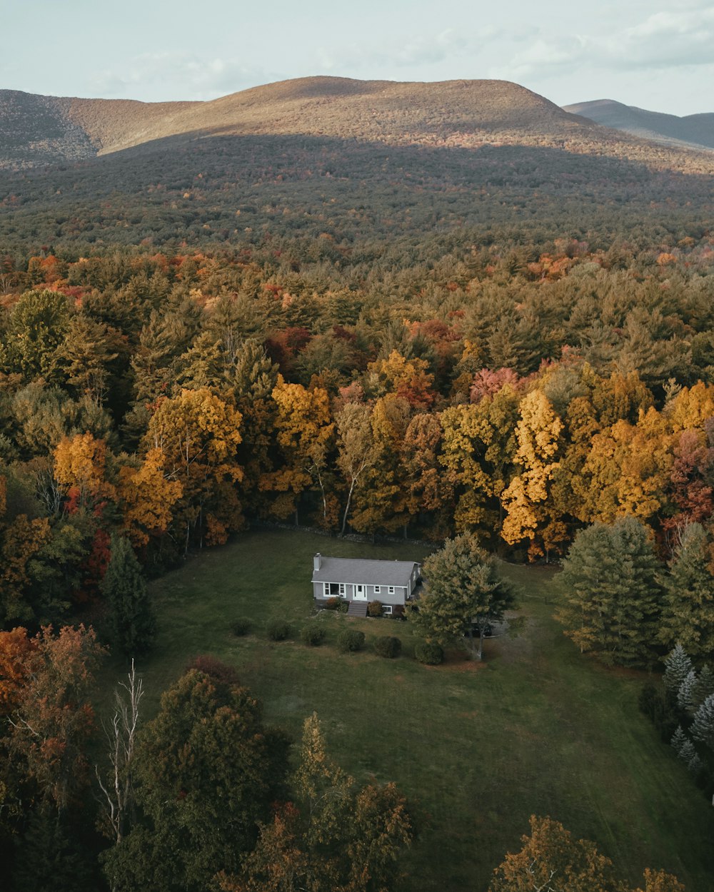 an aerial view of a house surrounded by trees