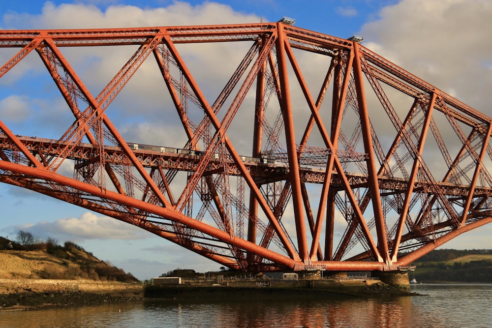 a large red bridge spanning over a body of water