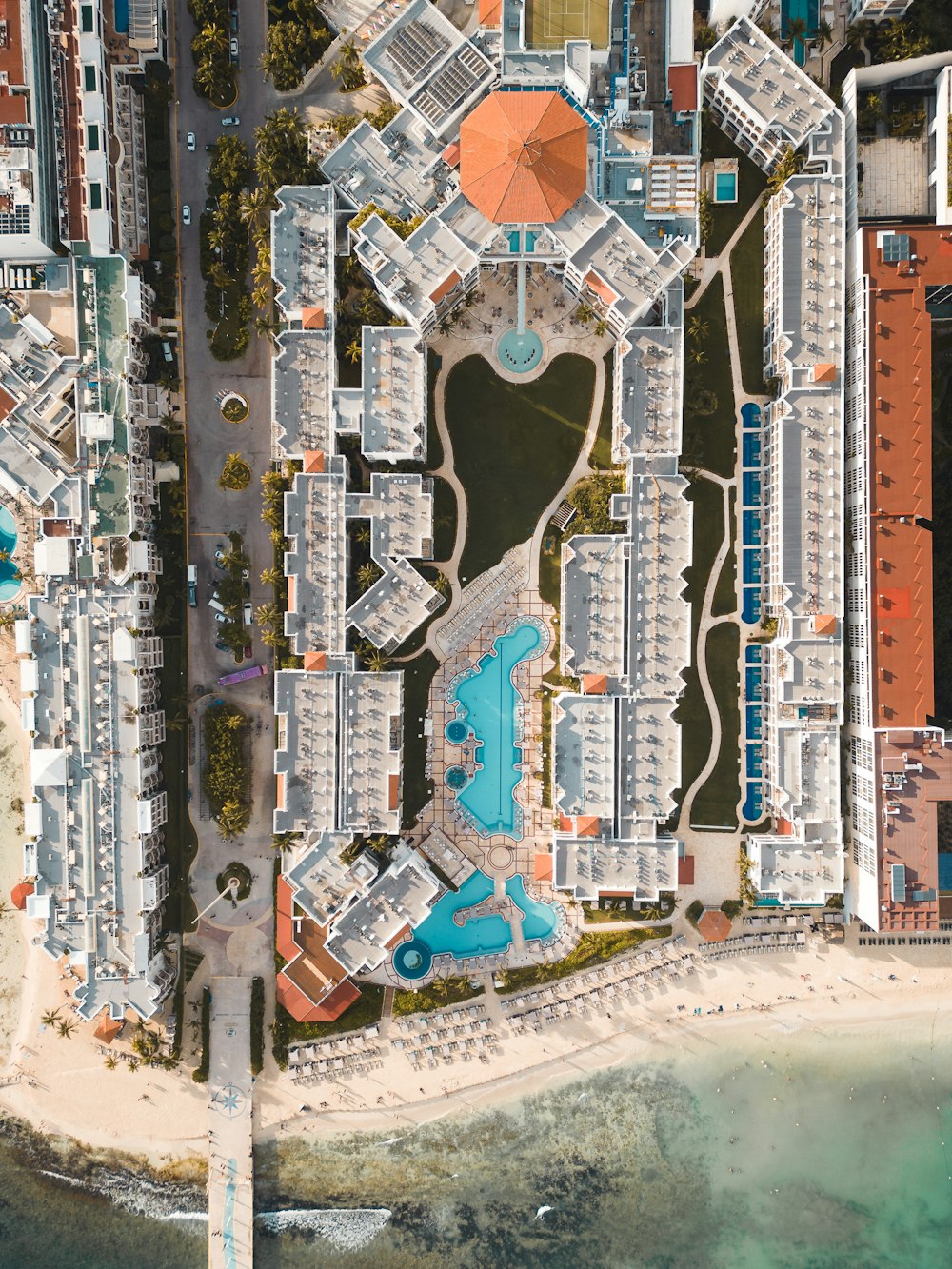 an aerial view of a beach resort with a pool