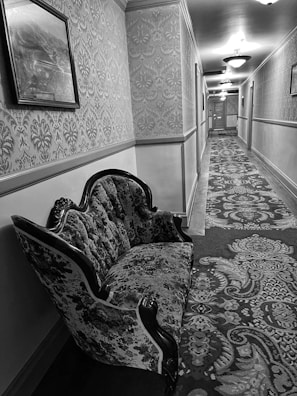 A softly lit hallway with framed art and a vintage rug adding warmth.