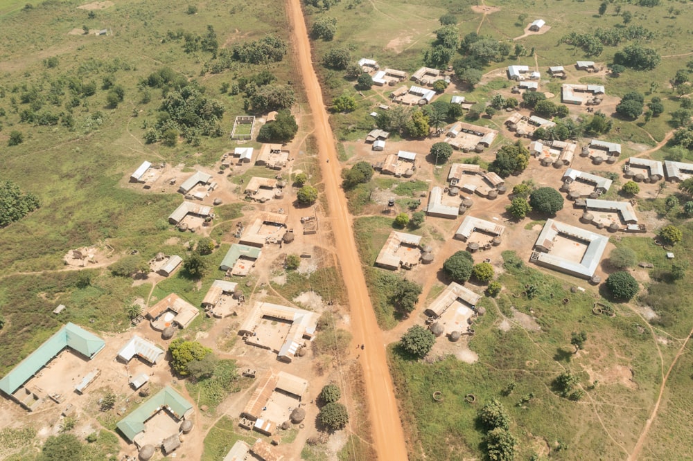an aerial view of a village in the middle of a field