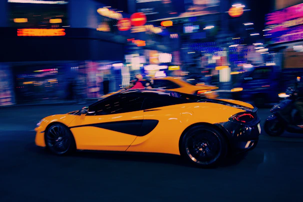 A sleek racing game interface showing a car speeding through a neon-lit cityscape.