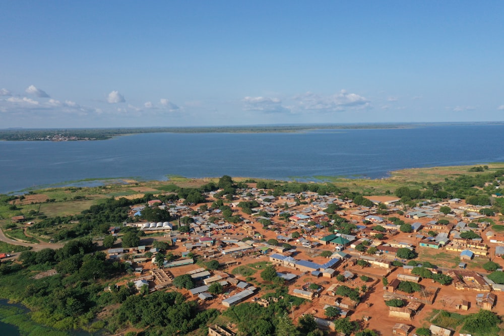 an aerial view of a village near a body of water