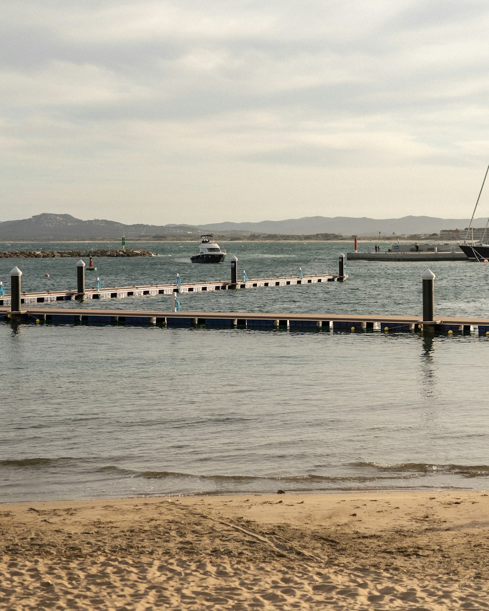 a boat is docked at a pier on the water