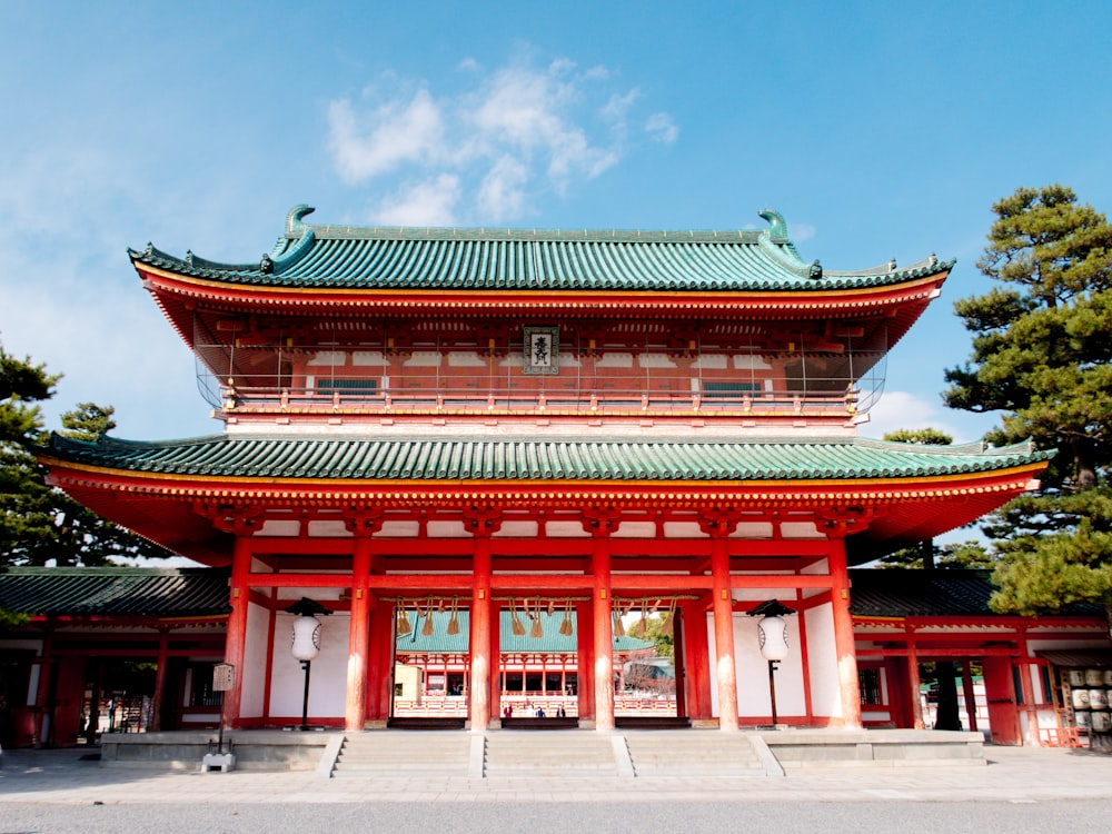 a tall red building with a green roof