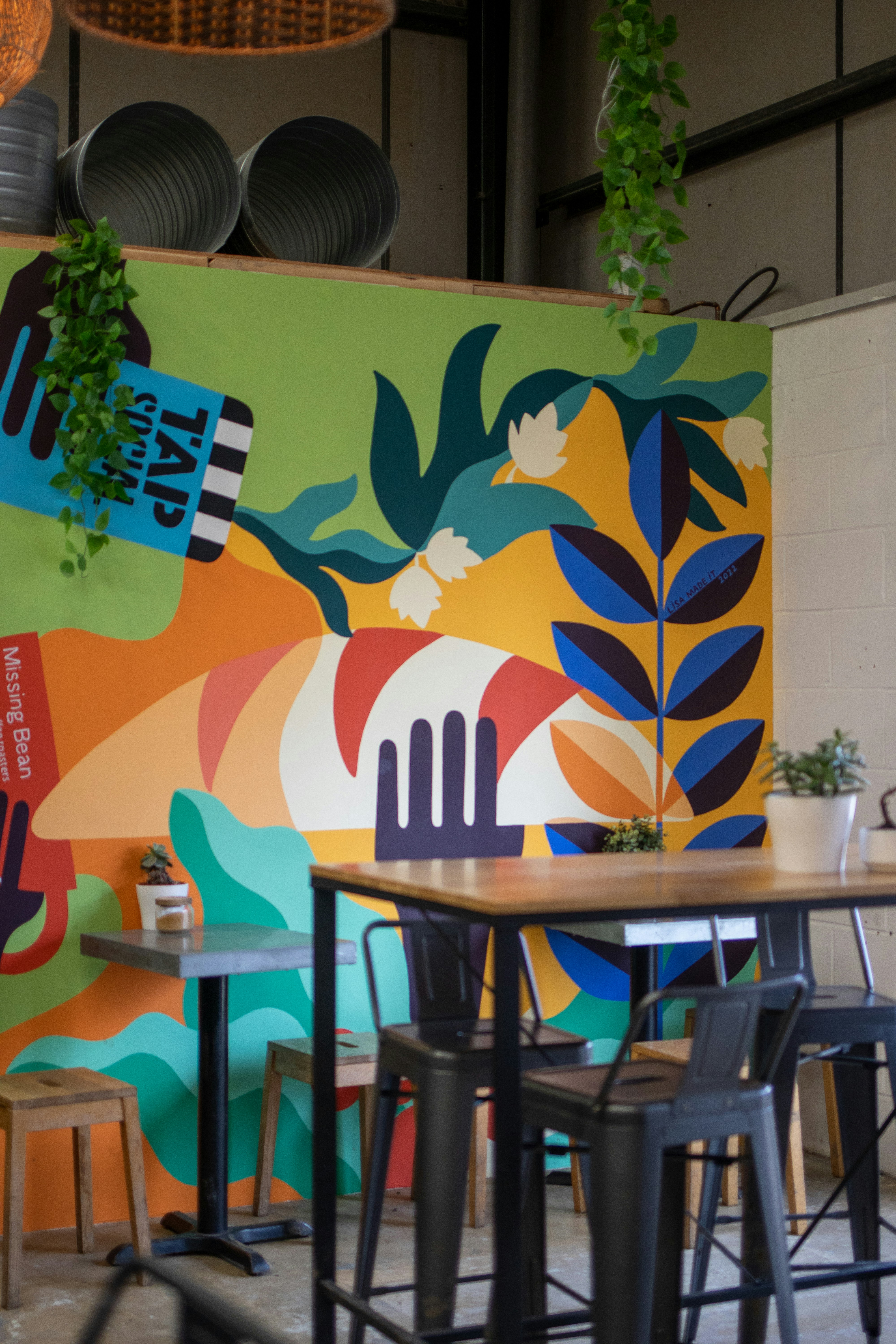 a colorful mural on the wall of a restaurant