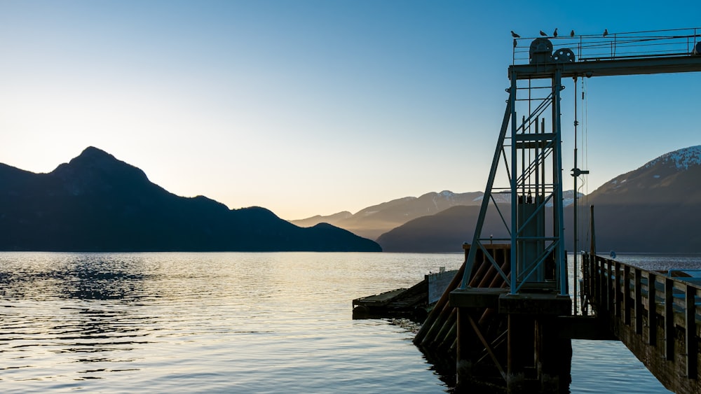 a boat dock with mountains in the background