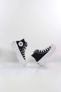 a pair of black and white converse sneakers