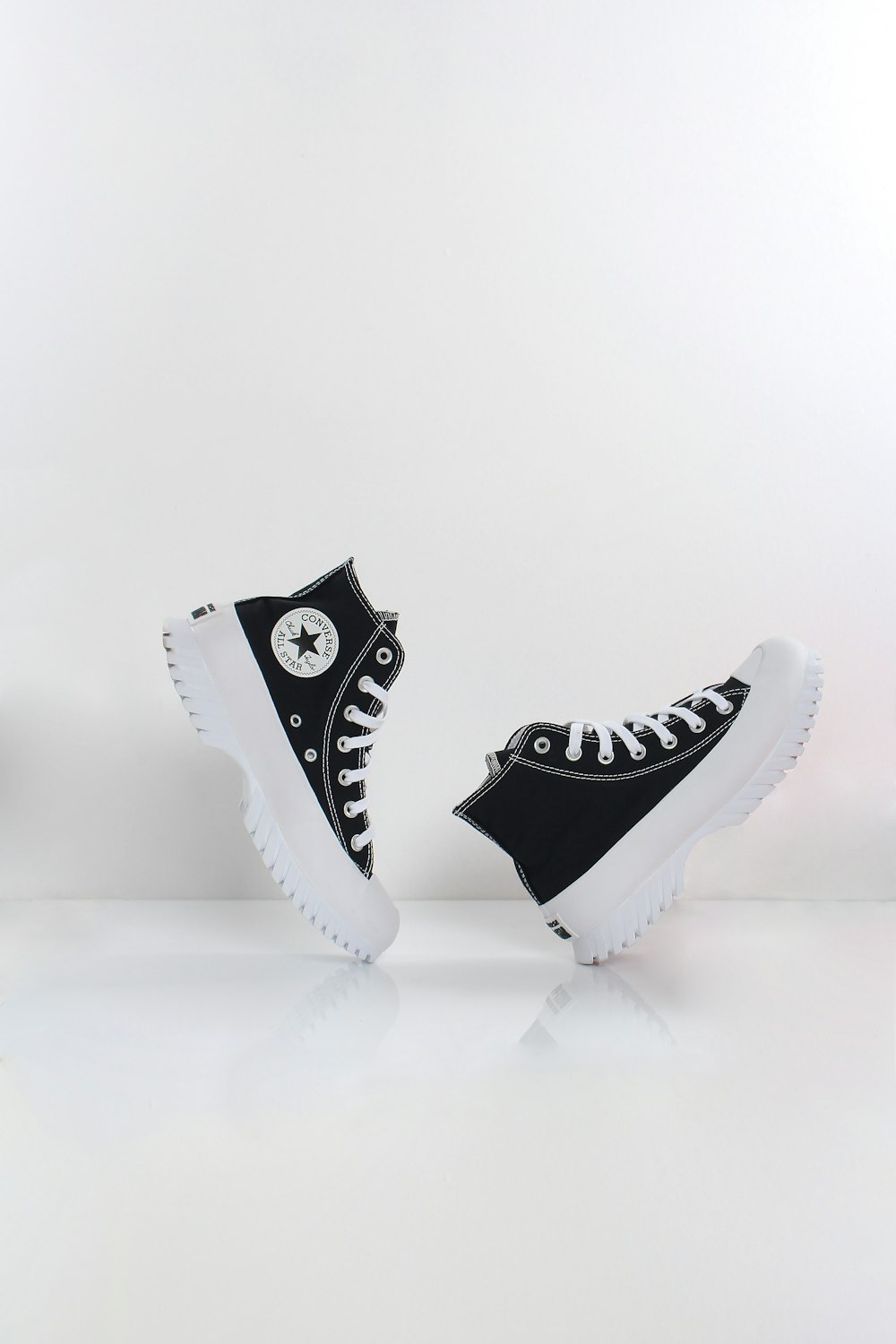 a pair of black and white converse sneakers