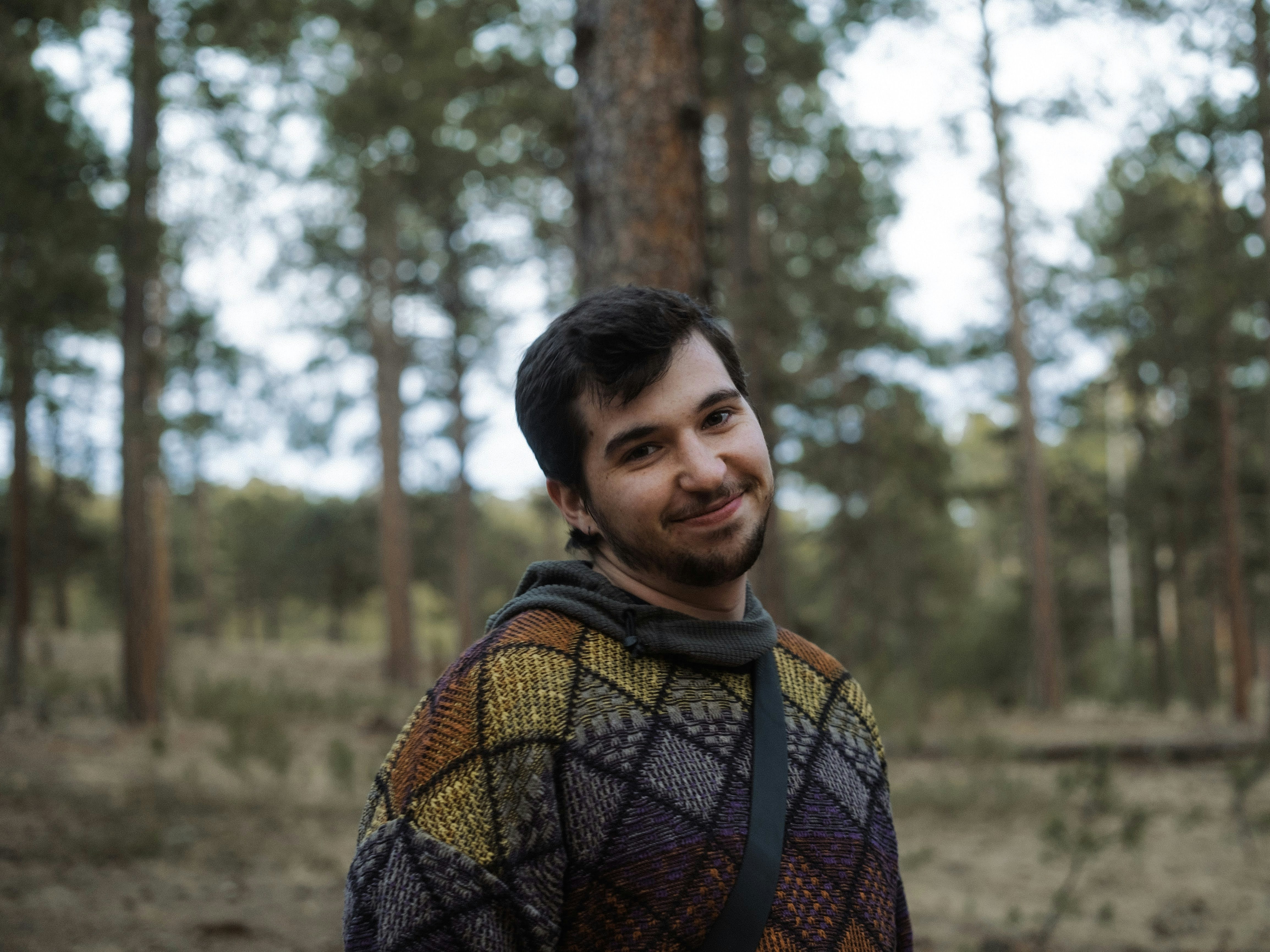 a man standing in the middle of a forest