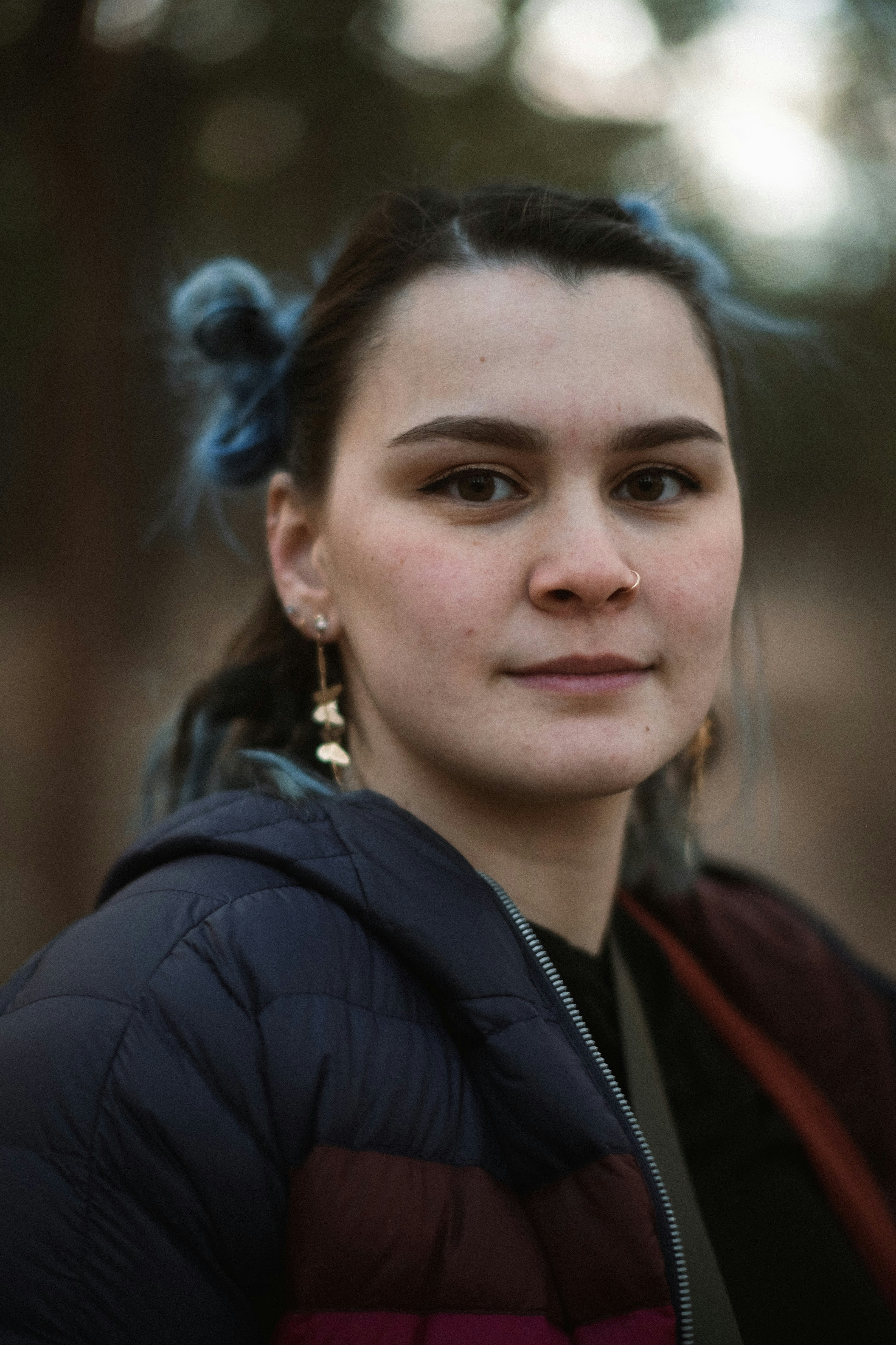 a woman in a black jacket with a ponytail