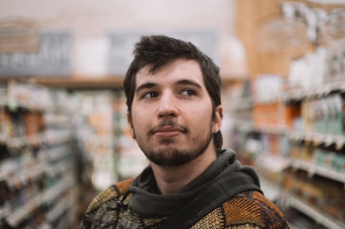 Close-up of a shopper's thoughtful expression while engaging with a product display.