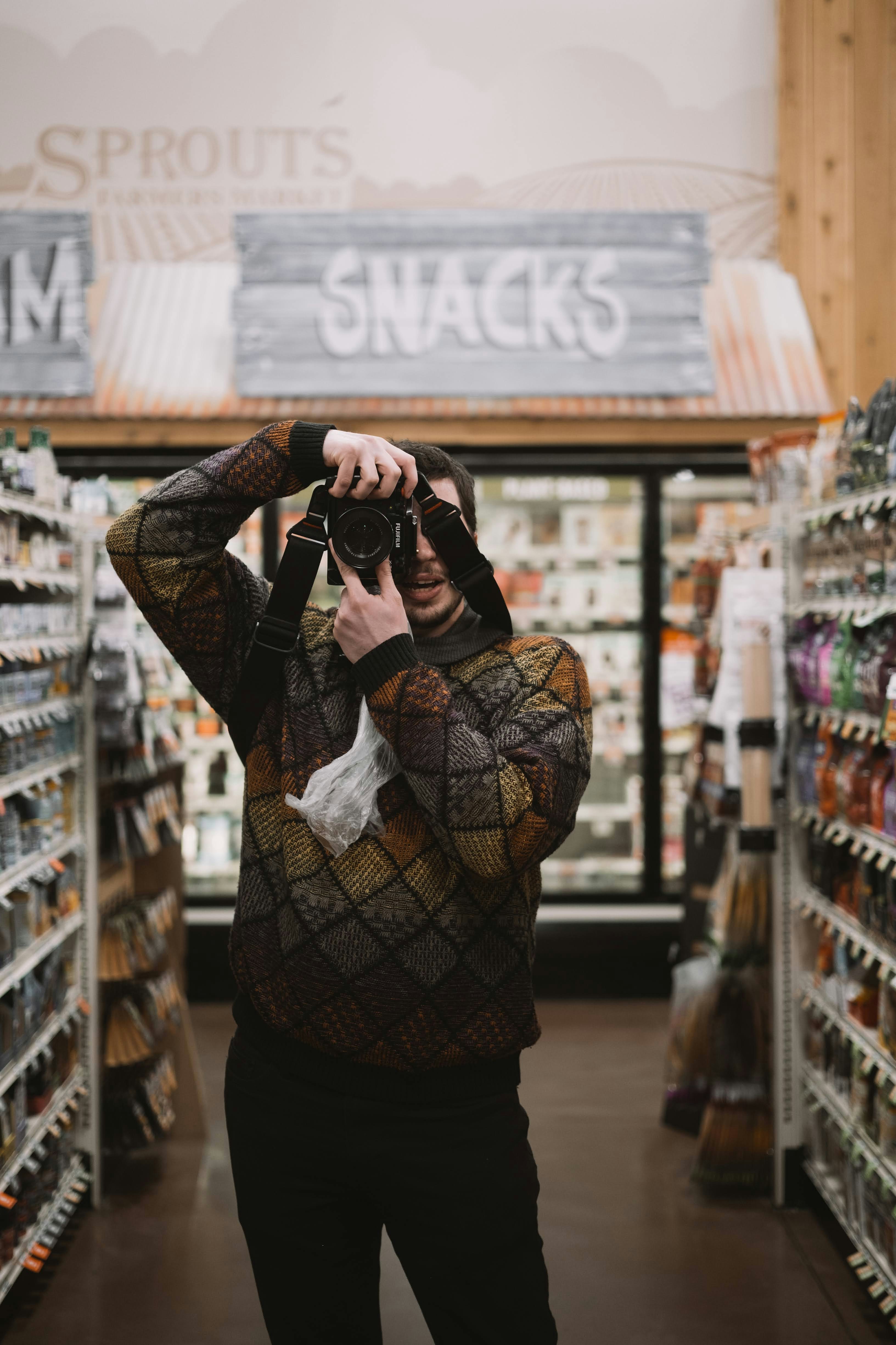 a woman taking a picture of herself in a store