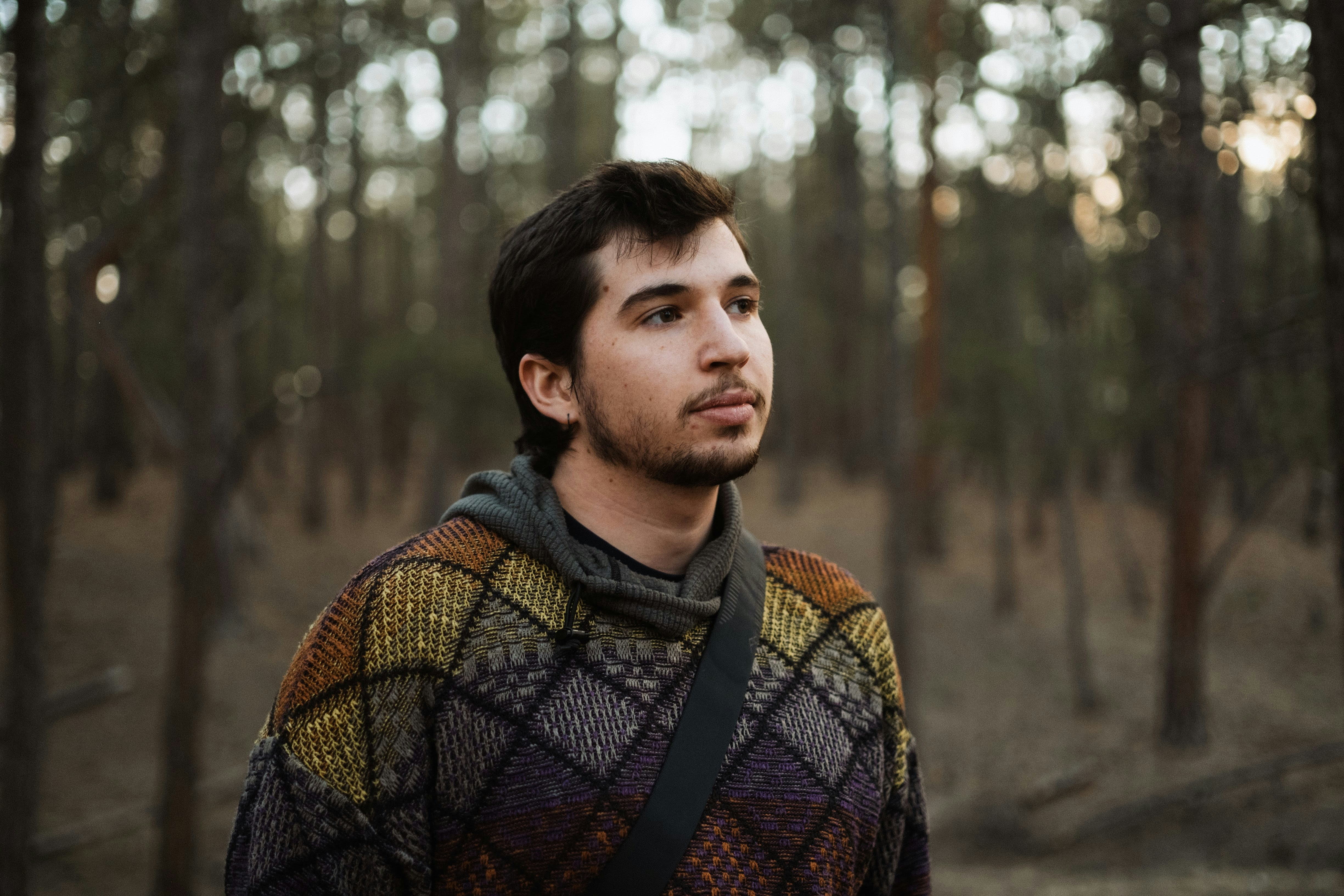 a man standing in the middle of a forest
