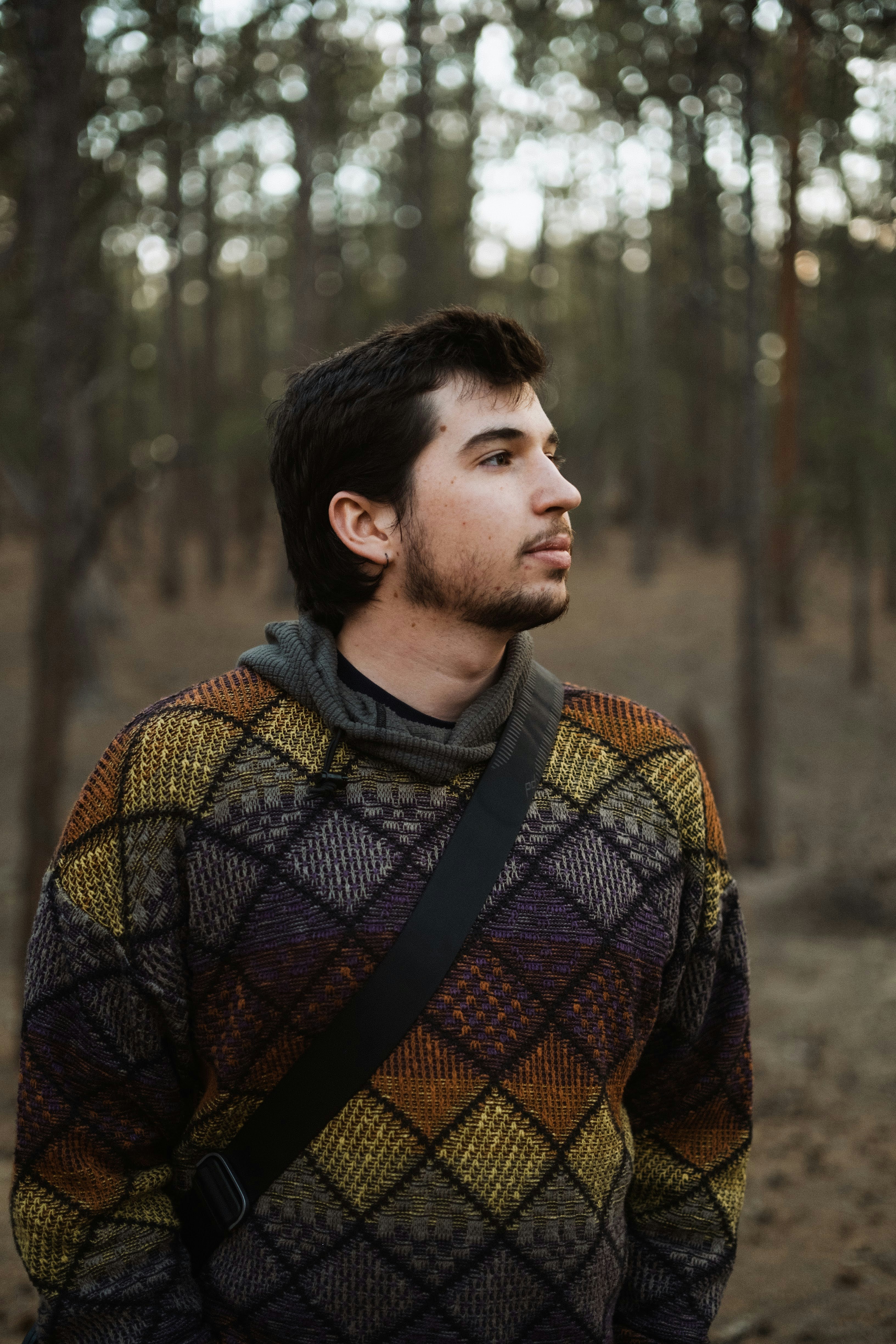 a man standing in the middle of a forest