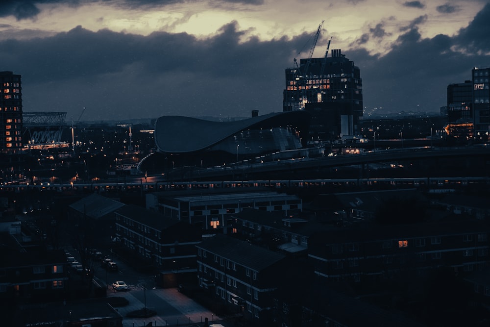 a view of a city at night with clouds in the sky