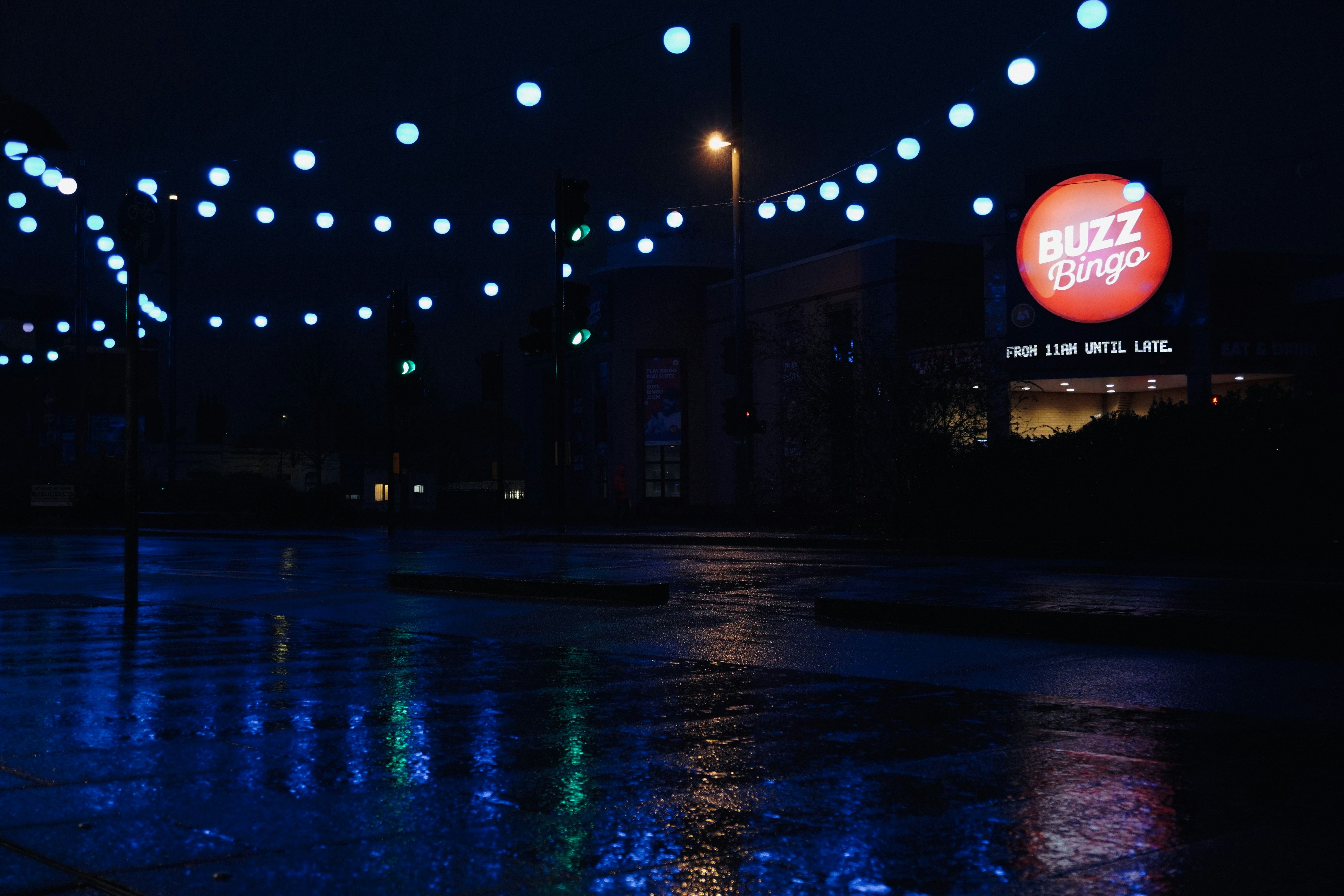 a city street at night with blue lights