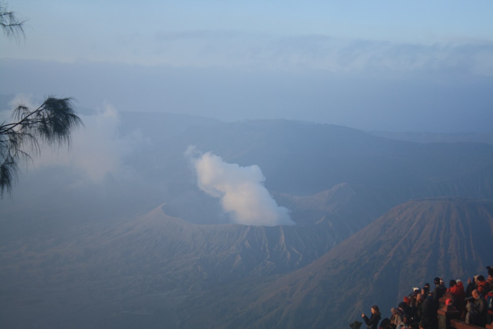 a group of people standing on top of a mountain