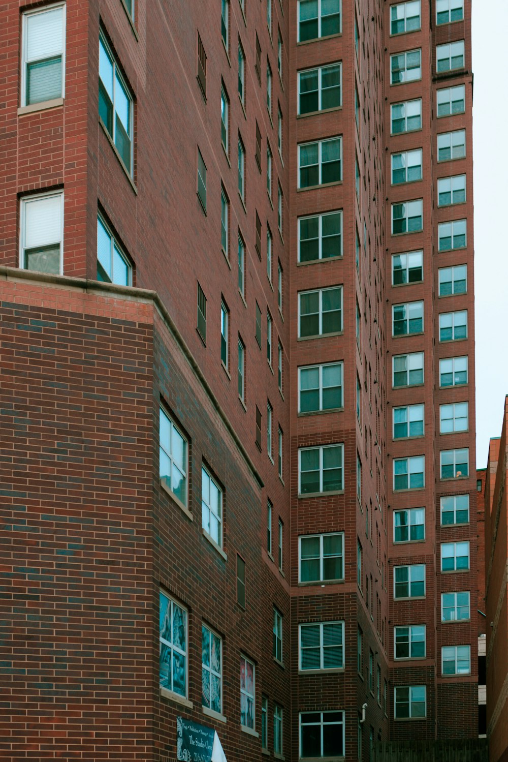 a man riding a skateboard down a street next to tall buildings