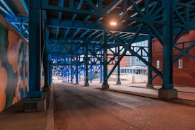 an empty street under a bridge at night