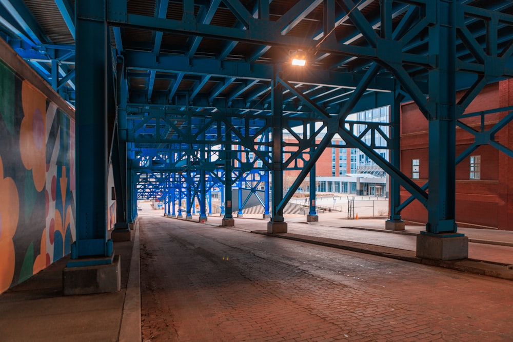 an empty street under a bridge at night