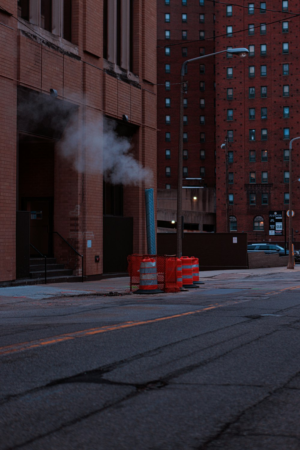 smoke coming out of a pipe on a city street