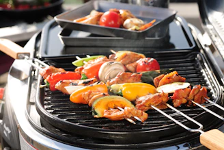 An overhead shot of colorful veggies and skewers arranged neatly on a Lumea grill grate.