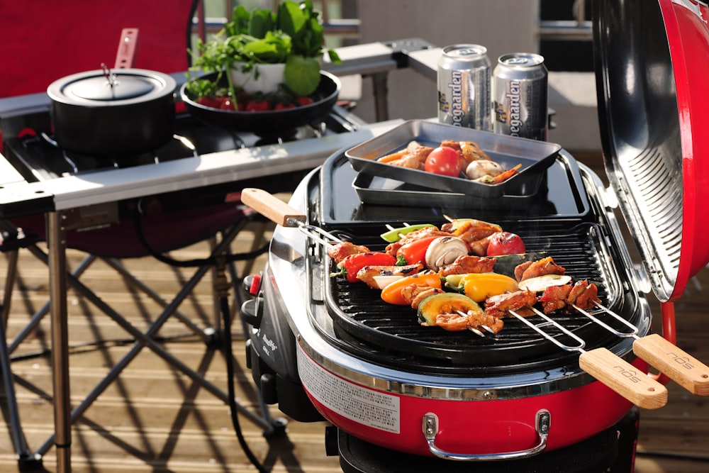 a bbq grill with a variety of food cooking on it