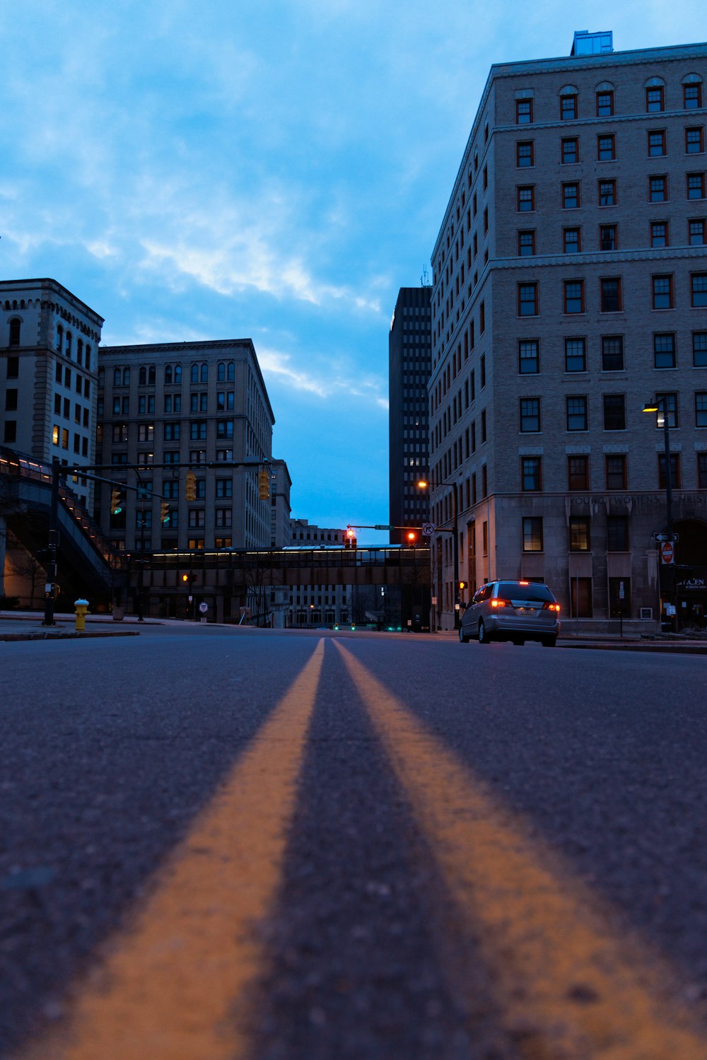 a city street with two yellow lines painted on the road