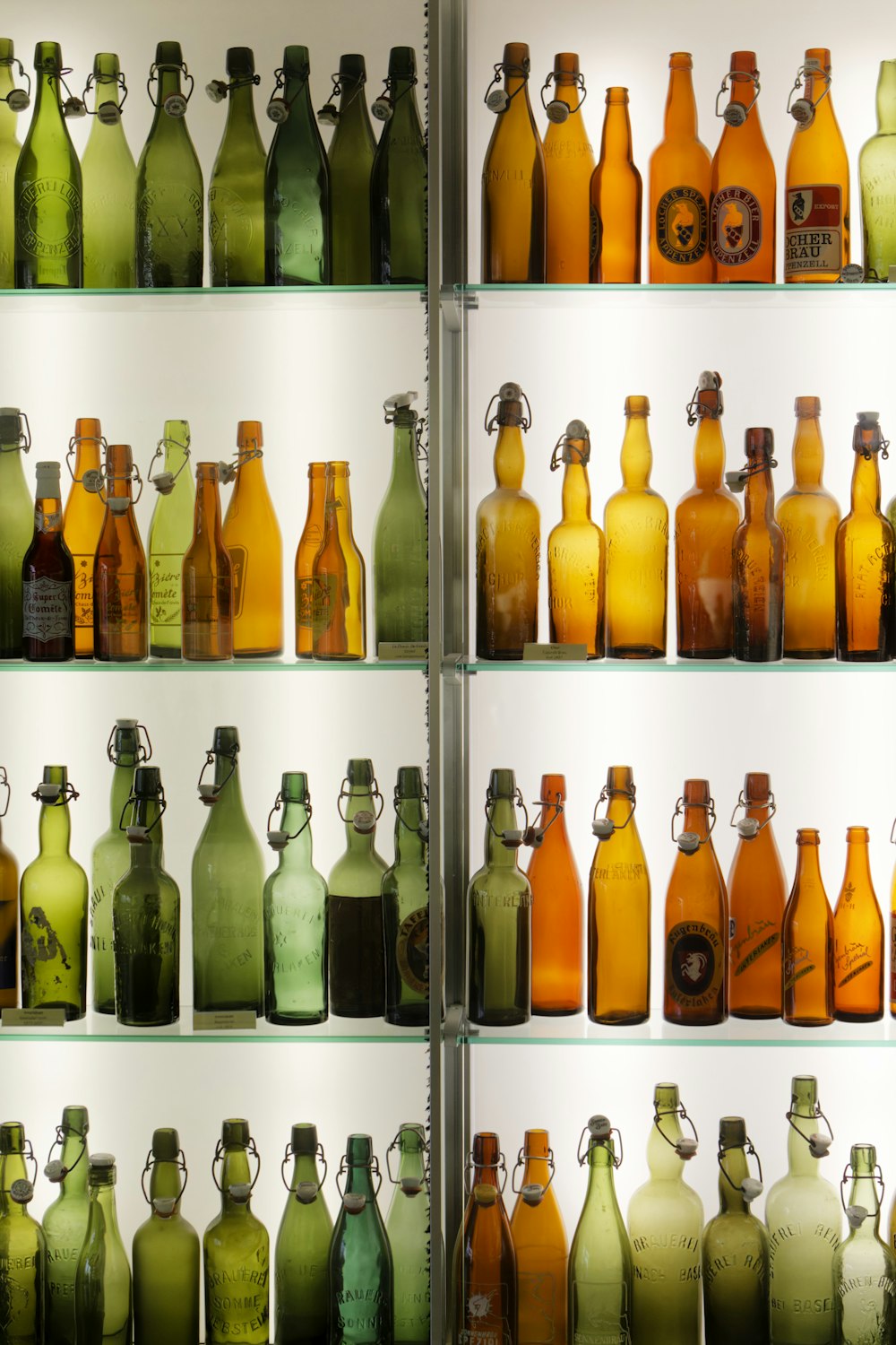 a shelf filled with lots of different colored bottles