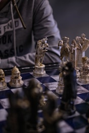 a man is playing chess on a chess board